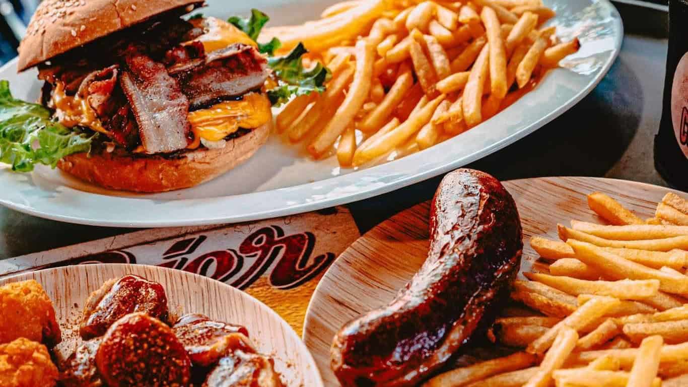 A selection of ML Imbiss food: our famous Smash Burger with french fries, homemade German sausage and homemade Currywurst